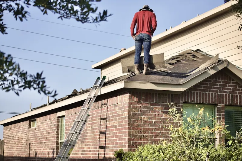 Professional roofer working on a residential roof in Scituate Center